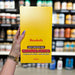 Close-up of (Barebells Soft Protein Bar 12x55g) held up inside My Supplement Shop, clearly showing the front label in a Sports Nutrition setting.